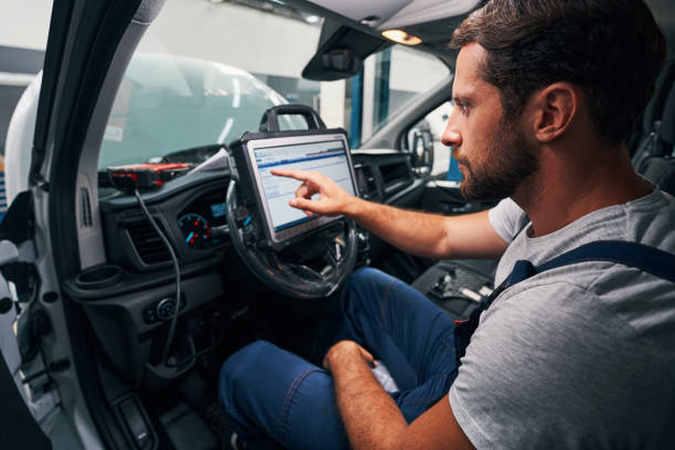 auto mechanic providing car diagnostics in cabin[1]